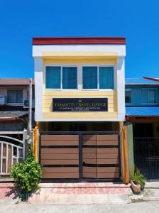a house with a garage door in front of it at Ysamatti Travel Lodge in Bankal