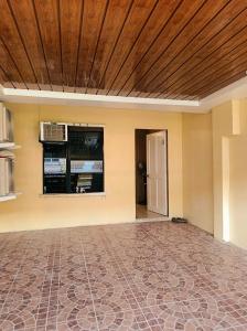 an empty living room with a wooden ceiling at Ysamatti Travel Lodge in Bankal