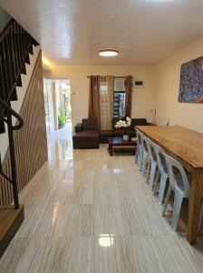a living room with a wooden table and chairs at Ysamatti Travel Lodge in Bankal