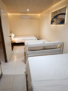 a room with three beds in a room at Ysamatti Travel Lodge in Bankal