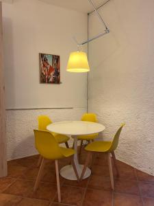 a table and chairs in a room with a lamp at Olivetta House Holiday in Moneglia