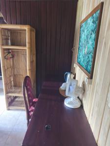 a wooden table with a phone on top of it at Puri Alam Bali in Munduk +39 photos