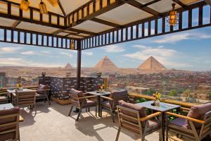 a restaurant with a view of the pyramids at Premium Pyramids BoutiQue With Rooftop Access in Cairo