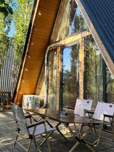 a wooden table and chairs on a patio at Glamping baytik in Verkhnyaya Alaarcha