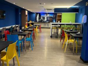 a restaurant with tables and chairs and a bar at ibis budget Petropolis in Petrópolis