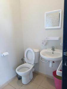 a bathroom with a toilet and a sink at Bonnes vacances in Ifrane