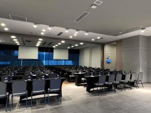 a large room with tables and chairs in it at Novotel Medellin El Tesoro in Medellín +219 photos