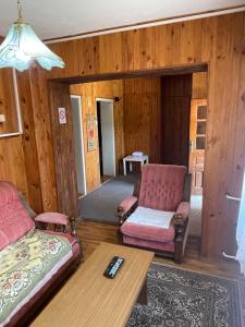 a living room with two chairs and a couch at Yellow House in Ritopek