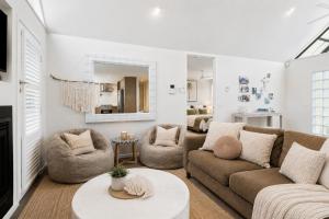 a living room with two couches and a table at Kos Place in Blairgowrie by Ready Set Stay in Blairgowrie +10 photos