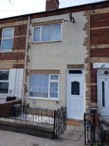 a brick house with a white door and windows at Modern 3BDR Home l Sleeps 5 l Free Parking l Close to Train station and Shops in Worksop