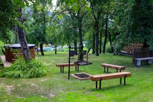 a park with benches and a playground in the grass at Pod Dzwonkiem in Jasienica