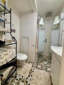a bathroom with a shower and a toilet and a sink at Beachfront Studio, fully equipped in Netanya +41 photos
