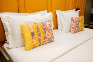 two pillows sitting on top of a bed at Urvi Banquets & Guest House in kolkata