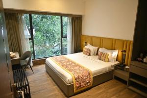 a hotel room with a bed and a window at Urvi Banquets & Guest House in kolkata +37 photos
