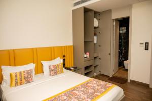 a bedroom with a large bed with pillows at Urvi Banquets & Guest House in kolkata