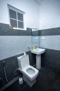 a bathroom with a toilet and a sink at Villa Akeinya in Matara +23 photos