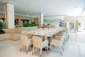 a long dining room with a long table and chairs at Xanadu International Resort in Koh Rong Sanloem