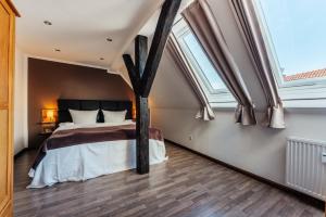 a bedroom with a large bed with an arched window at Fichtenblick in Sankt Andreasberg