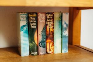 a row of books sitting on a shelf at Fichtenblick in Sankt Andreasberg +12 photos