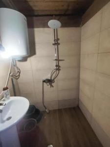 a bathroom with a sink and a lamp in a room at Getaway in Chʼkhakoura