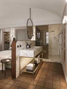 a bathroom with a large sink and a shower at BORGO MONCHIERO HERITAGE by Atmosphere in Monchiero +44 photos