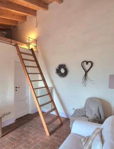 a living room with a staircase and a heart on the wall at Casa Fernanda in Albiano