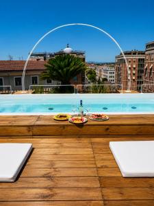 a view of a swimming pool with two plates of food at ZENIT Appartamenti & SPA in Terni