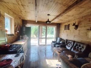 a living room with a couch and a stove at Getaway in Chʼkhakoura
