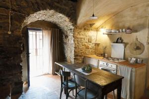 a kitchen with a table and chairs in a room at Casa Fernanda in Albiano +37 photos
