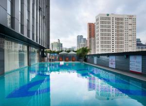 a large swimming pool in a city with tall buildings at Honder International Hotel in Guangzhou