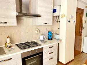 a kitchen with a stove and a counter top at Crateri e coralli in Mascali