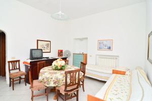 a room with a table with a computer and two beds at Residence Limoneto Ischia in Forio d'Ischia