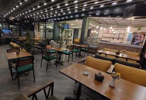 a restaurant with tables and chairs in a room at FAVORİTE Hotel in Söğütlü