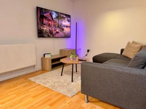 a living room with a couch and a table at Padborg Inn - Simple Rooms & Modern Apartments in Padborg