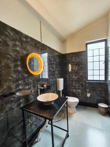 a bathroom with a sink and a toilet at Urbanest B&B in Shillong