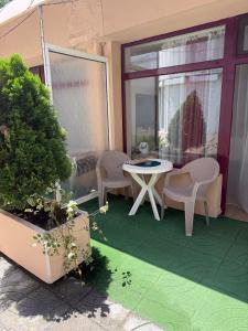 a patio with a table and chairs on a balcony at Hotel Acropolis in Varna City