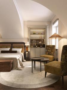 a bedroom with a bed and a table and a chair at BORGO MONCHIERO HERITAGE by Atmosphere in Monchiero