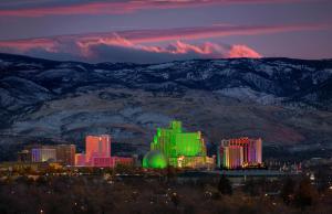 a city lit up at night with mountains in the background at Eldorado Reno Hotel & Casino - A Caesars Rewards Destination in Reno