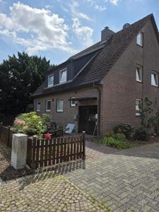 a brick house with a fence in front of it at Schick Hamburg in Geesthacht