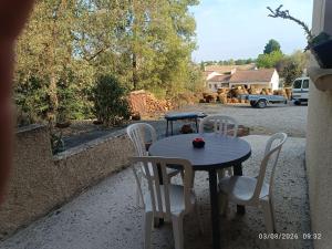a table and chairs sitting on a patio at La lisière tarnaise in Labastide-de-Lévis