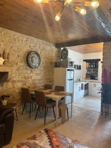 a kitchen and dining room with a table and chairs at Hélios ranch in Varennes-le-Grand
