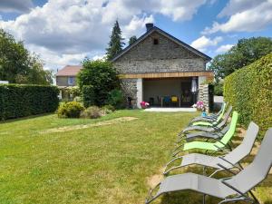 a row of lawn chairs sitting in a yard at Le refuge de Julia in La-Roche-en-Ardenne