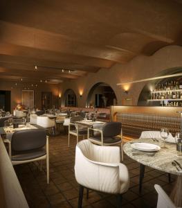 a restaurant with tables and chairs and a bar at BORGO MONCHIERO HERITAGE by Atmosphere in Monchiero