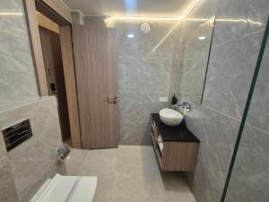 a bathroom with a sink and a shower at Hotel Om Sai Villa Gomti Nagar, Lucknow in Lucknow