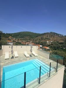 a swimming pool on the roof of a building at LURDE Apartamentos Rurales in El Cerezal