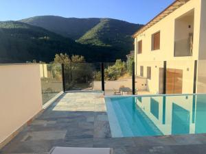 a house with a swimming pool next to a building at LURDE Apartamentos Rurales in El Cerezal