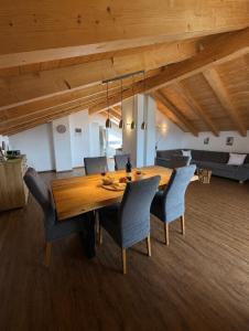 a dining room with a wooden table and chairs at Alpenwohnung Neuner in Wallgau