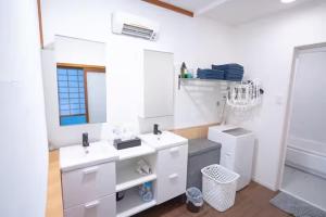 a white bathroom with two sinks and a mirror at Kujukuri SHICHIFUKU in Hasunuma +48 photos