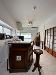 a kitchen with a island in the middle of a room at Kujukuri SHICHIFUKU in Hasunuma