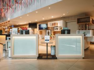 a store with two white signs in a room at ibis Juazeiro do Norte in Juazeiro do Norte